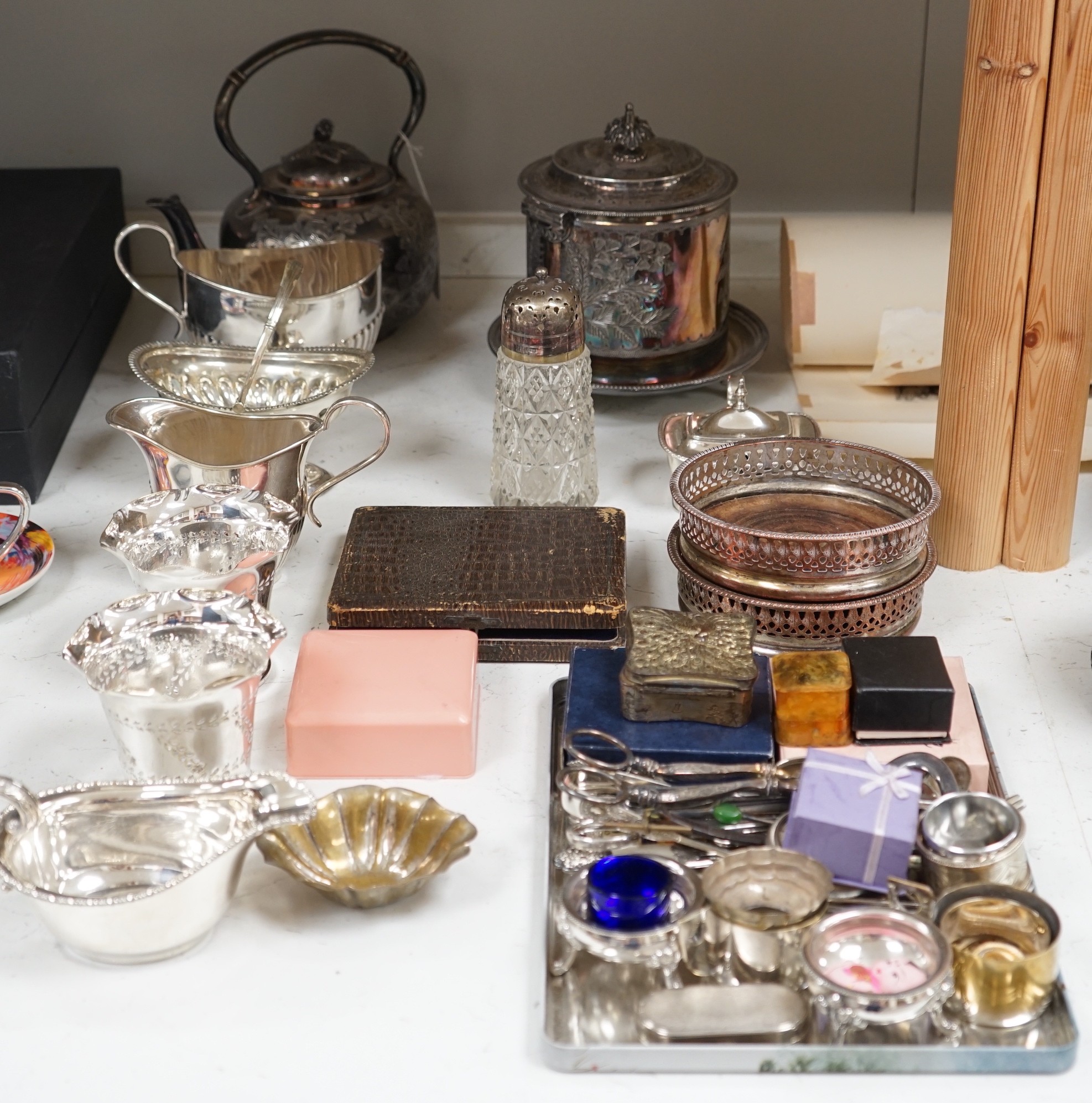 A collection of mixed silver plated wares, to include a pair of wine coasters, cream jug, novelty spoons, etc.